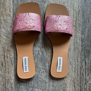 Pink sparkly flat sandals.